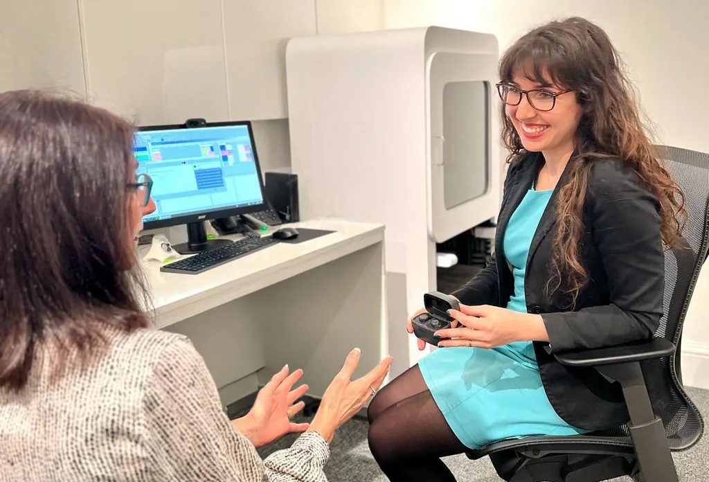 audiologist explaining hearing aid options after a hearing test